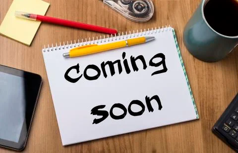 Coming soon - Note Pad With Text On Wooden Table Stock Photos