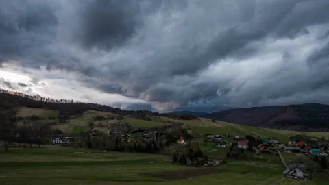 The coming storm time lapse over mountains,  clouds and rain and little village Stock Footage 301408583