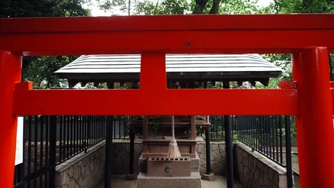 Coming through a torii gate to a small shrine in Japan Stock Footage 108570966