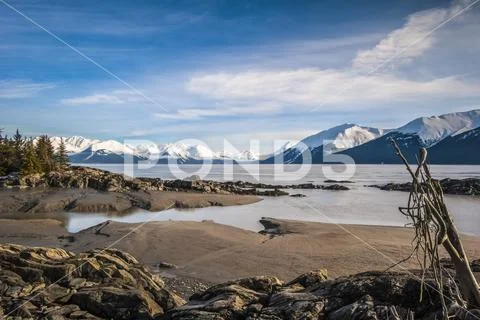 The in-coming tide on a calm winter day on the Turnagain Arm in South-central Al Stock Photos