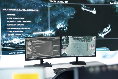 Command center monitors displaying code and satellite surveillance data Stock Photos