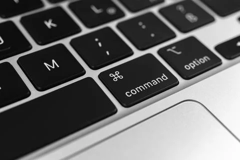 Command key and button on apple keyboard. Command sign close-up. Modern laptop Stock Photos