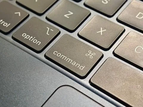 Command key on an Apple computer keyboard up close, Apple key tech brand ic.. Stock Photos