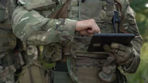 The commander gives the Ukrainian military tasks on the tablet. Stock Footage 219198822