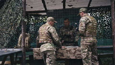 Commander Talks to Two Assistants in Forest Base Stock Footage 255652072