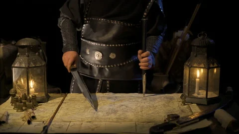 Commander working on map with sword in hand. Stock Footage 199202387