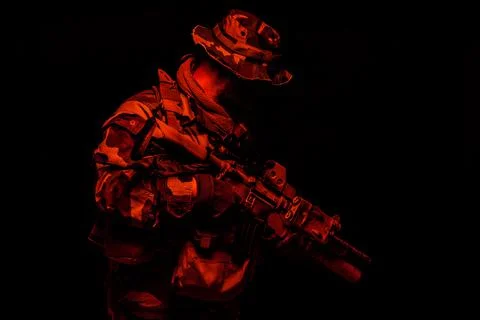 Commando soldier in battle ammunition, armed rifle Stock Photos