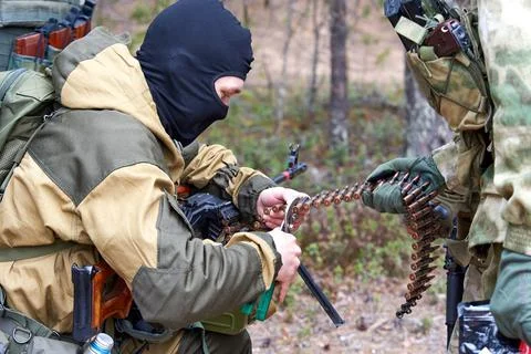 Commandos load a machine gun in the forest Stock Photos