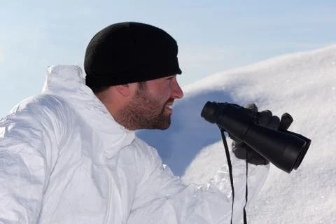 Commandos  in white camouflage looking through binoculars. portrait in profil Stock Photos