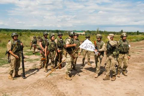 Commandos with white flag after atack at simulated enemy positions Stock Photos