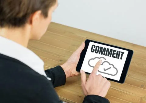 Comment text and cloud tick graphic on tablet screen with hands 写真素材