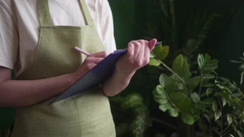 Commerce control. A small business owner takes notes on a tablet, close-up. A Stock Footage 172025389