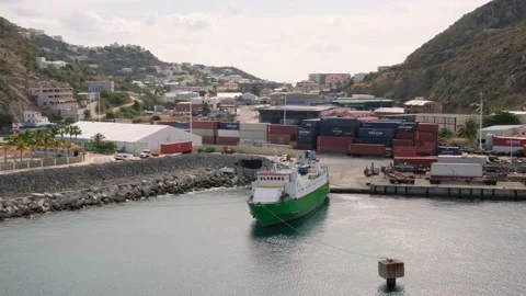 Commerce craft is fixed bow rope to freestanding bollard and docked by stern to Stock Footage 234029682