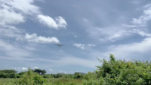 A commercial airplane flies by 스톡 동영상 212601014