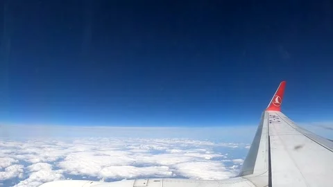 Commercial airplane flying over an endless sea of white clouds Stock Footage 337060651