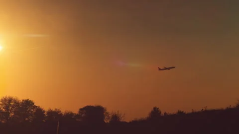 Commercial airplane flying at sunset with dramatic sky, Madrid, Spain Stock Footage 294029461