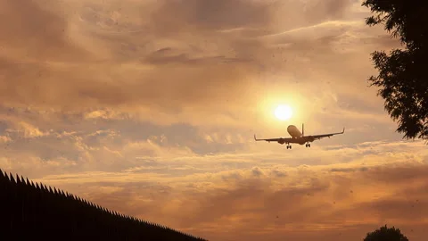 Commercial Airplane Landing at Sunset with Dramatic Sky Video stock 332793979