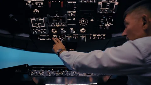 Commercial airplane pilot operating controls in cockpit Vidéo 326180335