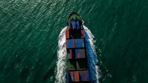 Commercial Cargo Ship Navigating Through Deep Ocean Waters High Angle Shot 库存照片