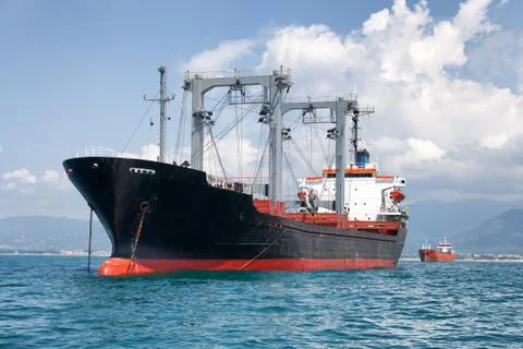 Commercial cargo ship on ocean Stock Photos