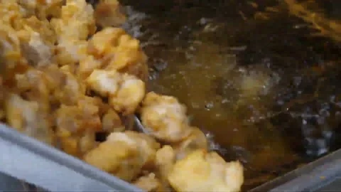 Commercial Deep Fryer Loading Battered Chicken Nuggets In Restaurant Kitchen 스톡 동영상 343027290