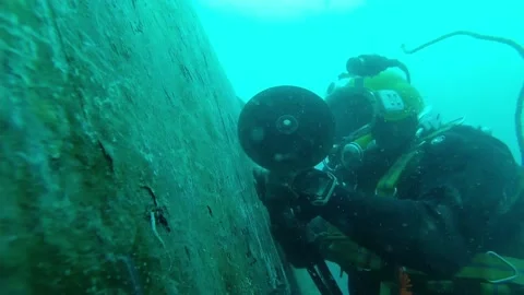 Commercial diver working with a pneumatic grinder.. Dangerous job Stock Footage 209673592