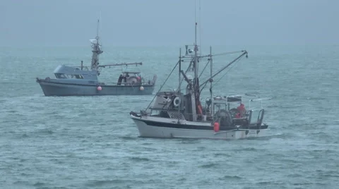 Commercial Fishing Boats Working In Increasingly Stormy Seas Stock Footage