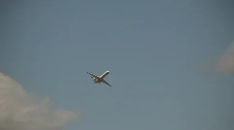 Commercial jet ascends through the cloudy blue sky Stock Footage 360141