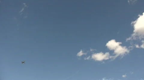 Commercial jet ascends through the cloudy blue sky Stock-Footage 360144