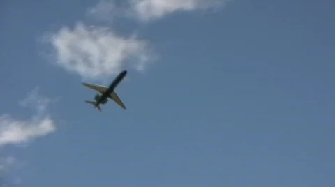 Commercial jet ascends through the cloudy blue sky Stock Footage 360146