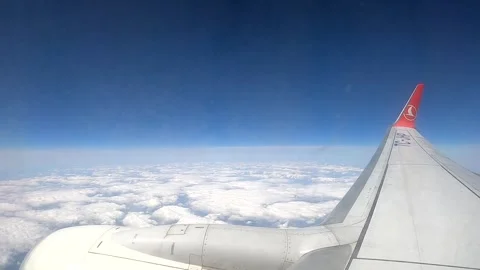 Commercial jet engine and wing flying at cruising altitude over clouds Stock Footage 337060650