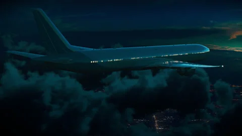 Commercial Jet Plane Flying Above Night City Stock Footage