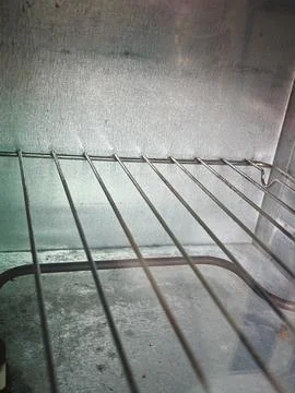 Commercial Kitchen Oven Interior with Empty Metal Rack and Heating Element Stock Photos