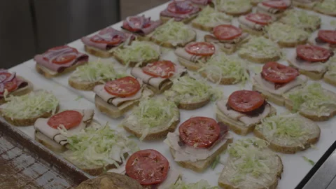 Commercial Kitchen table top full of sandwiches being made Stock Footage 220581778