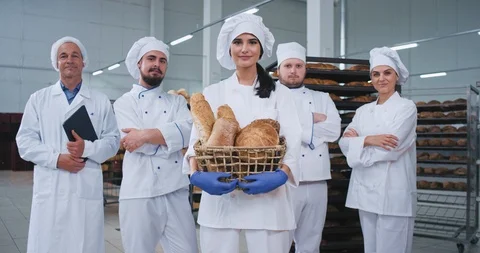 Commercial looking bakery main team bakers engineer in front of a beautiful lady Stock Footage 112345981