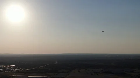 Commercial Plane Flying Towards Sun During Landing - 4k Drone Video Stock Footage