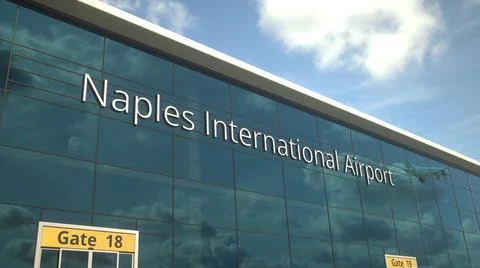 Commercial plane take off reflecting in the windows with Naples International Ilustración de archivo