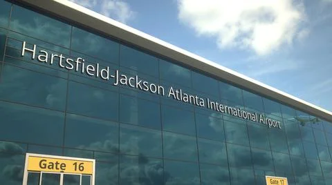 Commercial plane take off reflecting in the windows with Hartsfield-Jackson Ilustración de archivo
