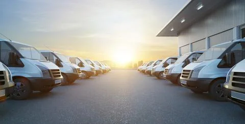 Commercial vans in two row with empty floor and factory building behide. Expr Ilustración de archivo