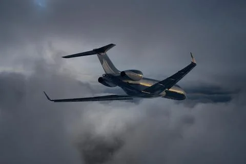 Commerical passenger airplane over the clouds with amazing sunset - Travel by Foto stock