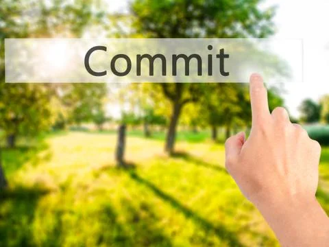 Commit - Hand pressing a button on blurred background concept on visual scree 스톡 사진