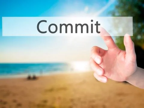 Commit - Hand pressing a button on blurred background concept on visual scree Stock Photos
