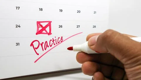 Commitment to consistent effort a hand marks 'Practice' on a calendar, high.. Stock Photos