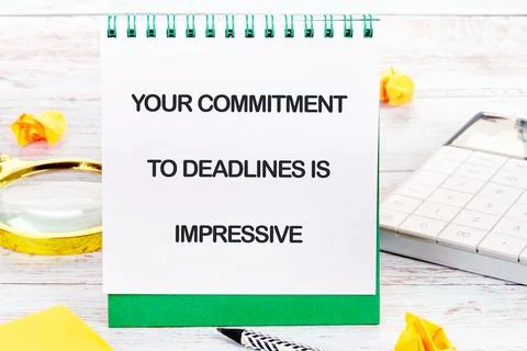 Commitment to deadlines shown through motivational notes and office supplie.. Stock Photos