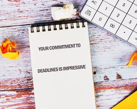 Commitment to meeting deadlines noted on notepad alongside a calculator and.. Stock Photos