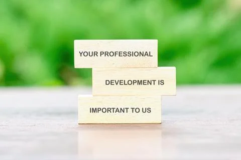 Commitment to professional development with wooden blocks displayed in a na.. Stock Photos