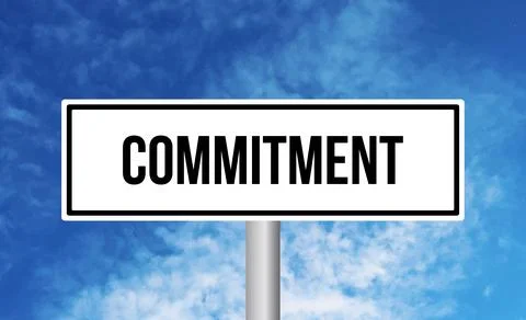 Commitment road sign on blue sky background Stock Photos