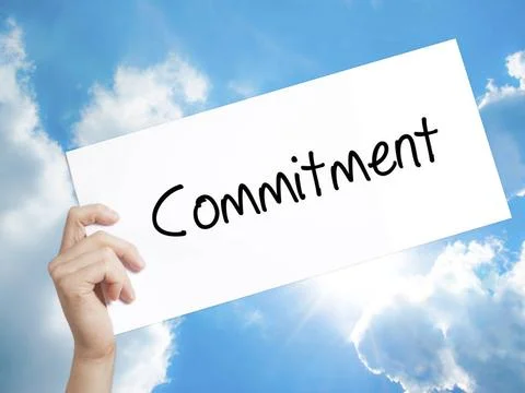 Commitment Sign on white paper. Man Hand Holding Paper with text. Isolated... Foto stock