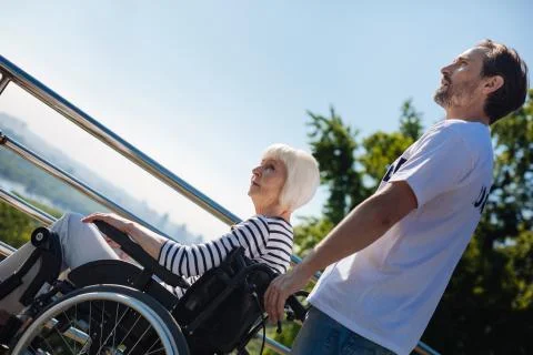 Committed gallant man taking care of elderly people Foto stock