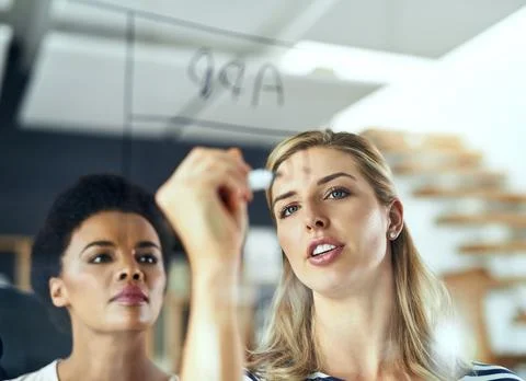 Committed to see the plan through from start to finish. two colleagues having a Stock Photos
